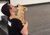 A lion cub loves his caretaker